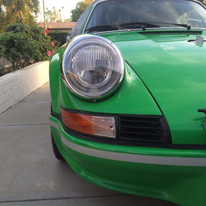 Classic car with Bosch 4487 flat fluted lens in clear and amber, highlighting sleek headlight design.