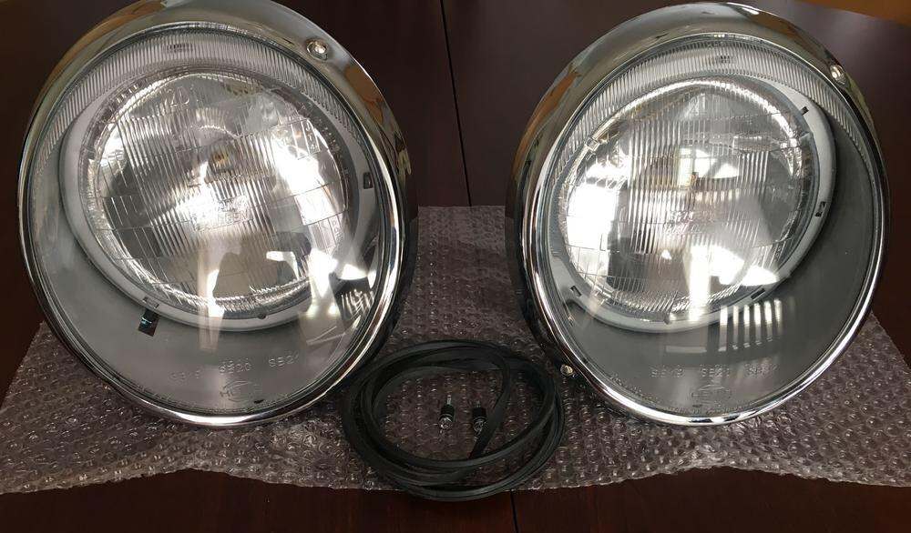 Restored 911 SWB Hella Sealed Beam Headlights with chrome trim rings.