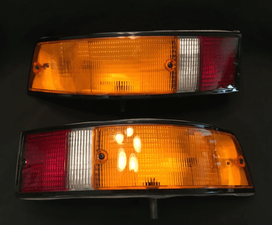 Restored Porsche 911 SWB turn signals and tail lights showcasing premium lenses and chrome-plated reflectors.