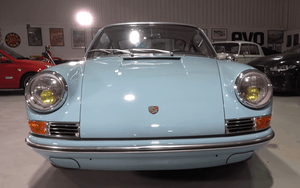 Front view of a vintage Porsche featuring restored Cibié Bi-Iode headlights from the Audette Collection.
