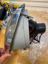 Load image into Gallery viewer, Cibié Bi-Iode 170mm headlight, restoration service for Porsche 911, side view with chrome trim and wiring.