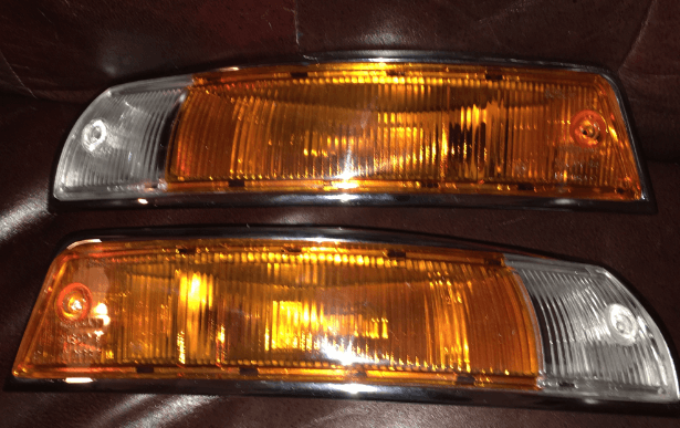 Restored Porsche 911 SWB turn signals and tail lights with high-quality lenses and chrome plating.
