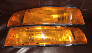 Restored Porsche 911 SWB turn signals showcasing premium chrome and high-quality amber lenses.
