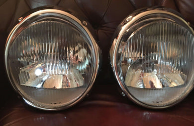 Restored Bosch H1 Headlights on leather surface.