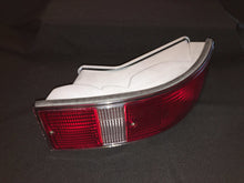 Load image into Gallery viewer, Restored Porsche 911/912 F-Series tail light against black background.