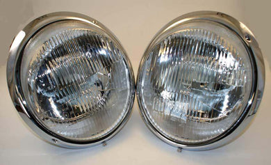 Restored Bosch H4 headlamps with chrome trim rings.