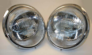 Restored Bosch H4 headlamps with chrome trim rings.