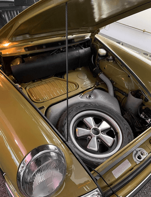 AC Group Buy: Carbon fiber hood prop in use under a car hood.