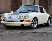 Load image into Gallery viewer, Classic white Porsche 911 with Cibié Bi-Iode headlights in urban setting.